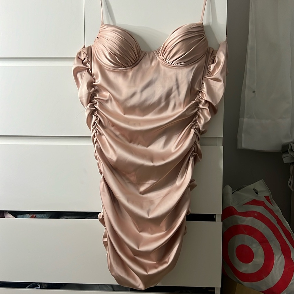 I am selling an Oh Polly rose gold/pink mini dress. It is a size US6.